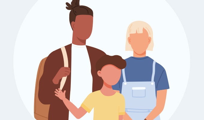 A family of three, with a young child stood in front of their parents